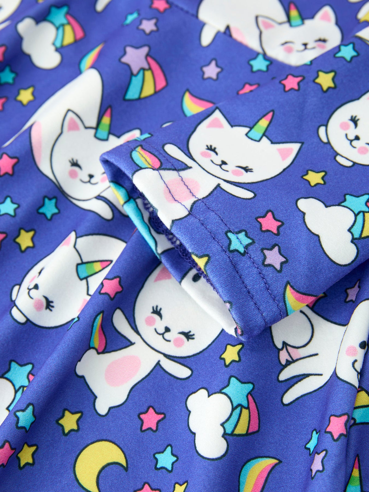 a blue fabric with cats and stars