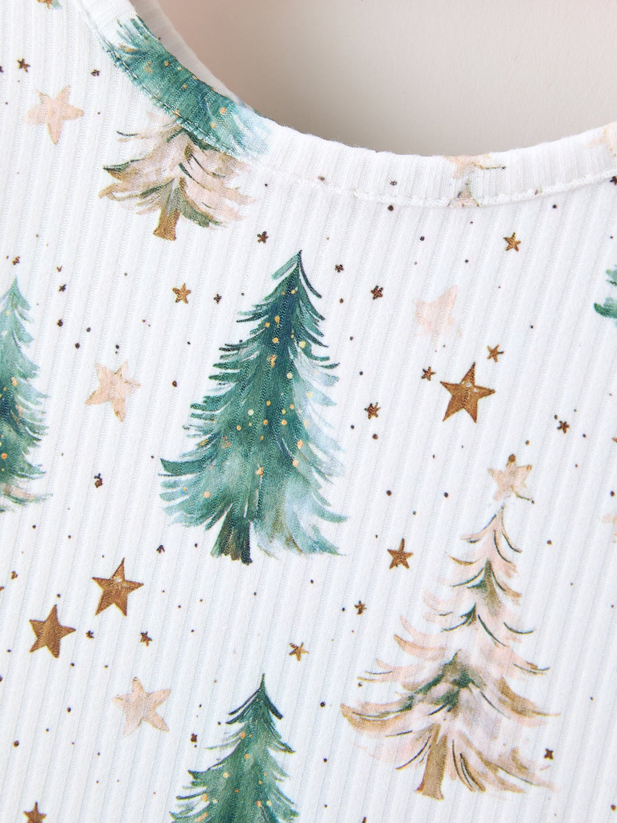 a white shirt with trees and stars on it