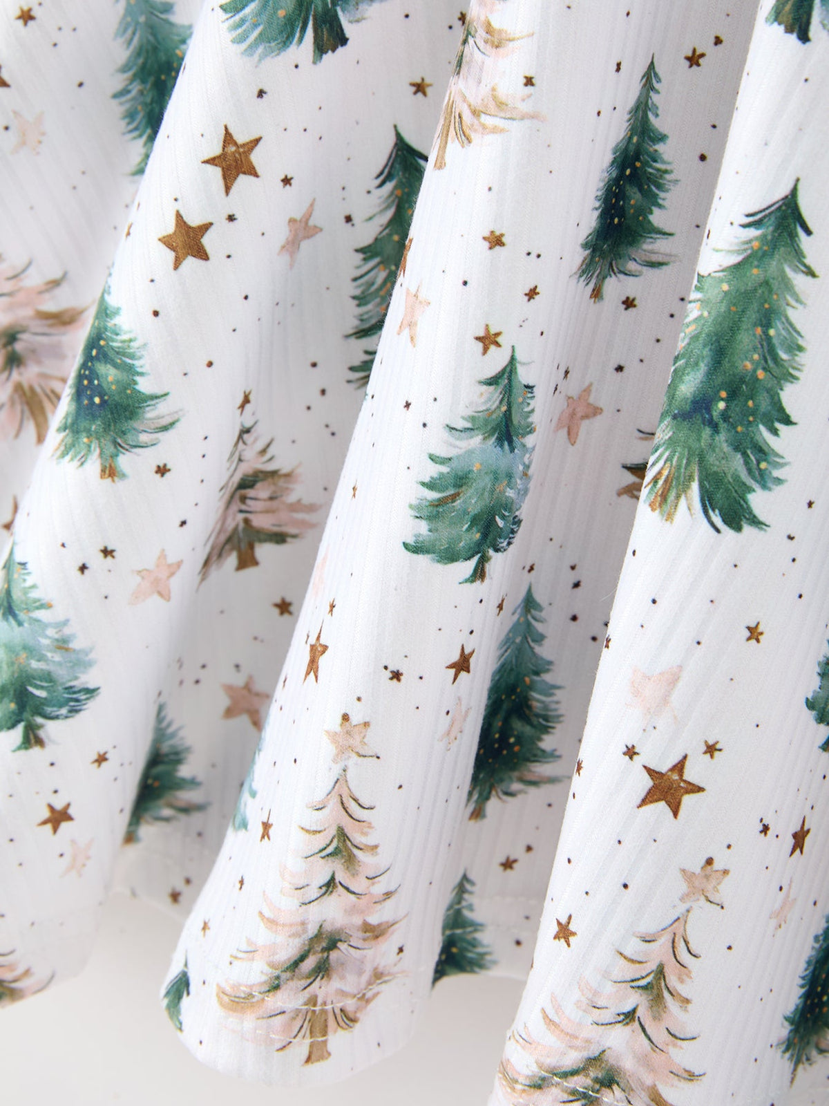 a white fabric with trees and stars
