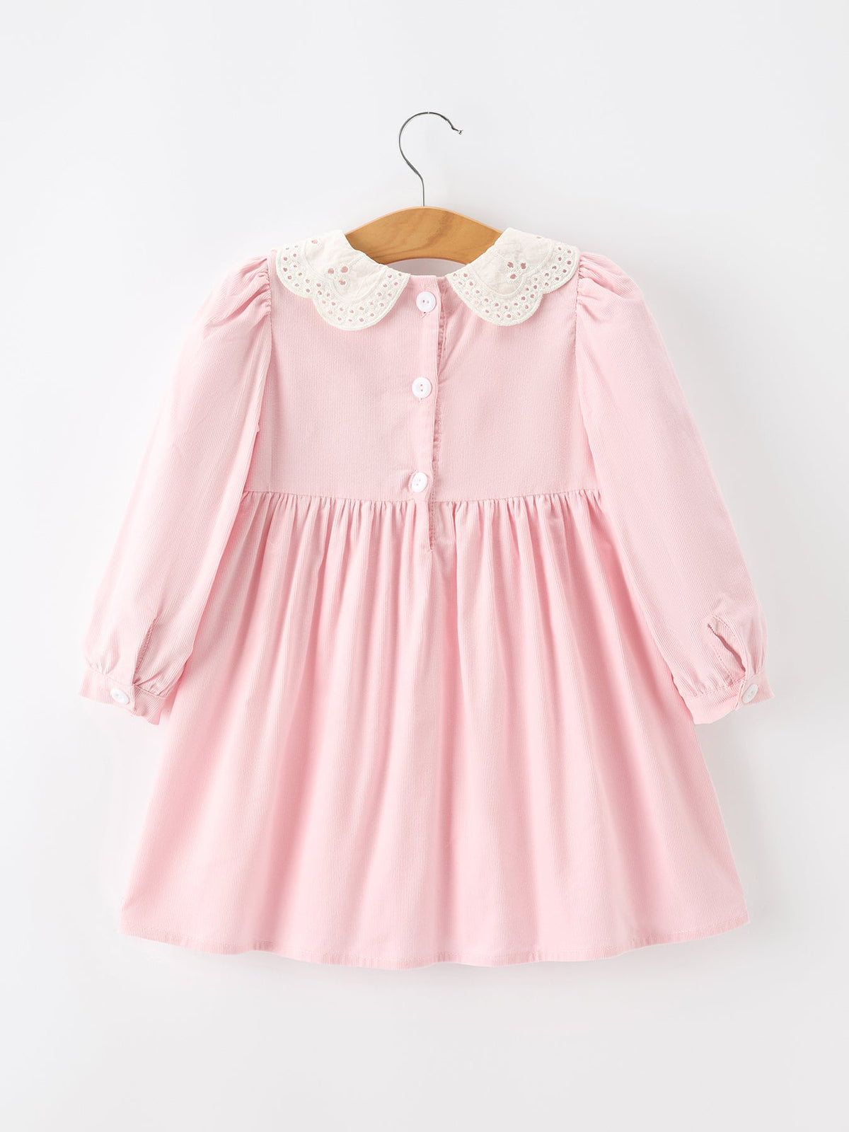 a pink dress with white lace on it