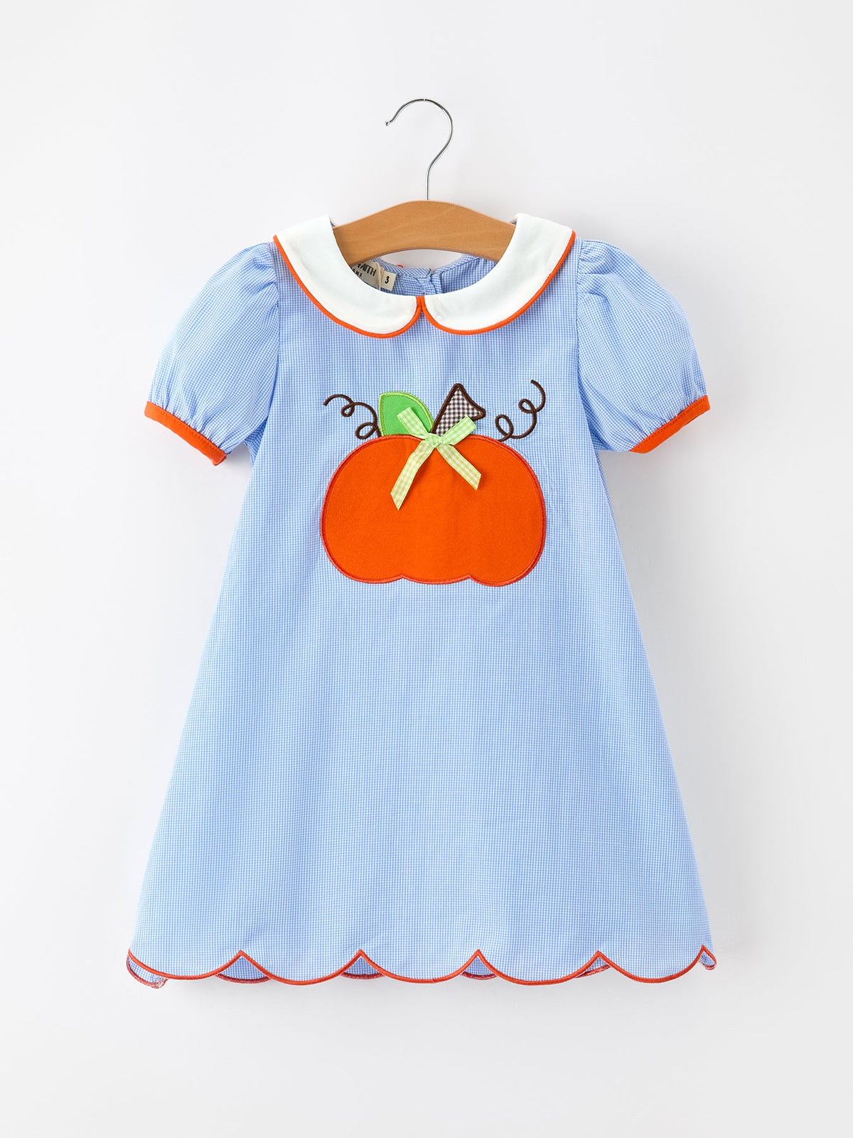 a blue and white striped dress with pumpkin applique