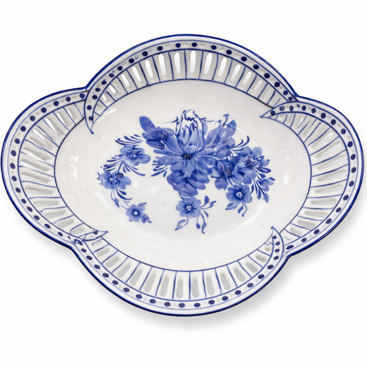 a blue and white plate with a flower design