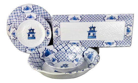 a group of blue and white china plates and bowls