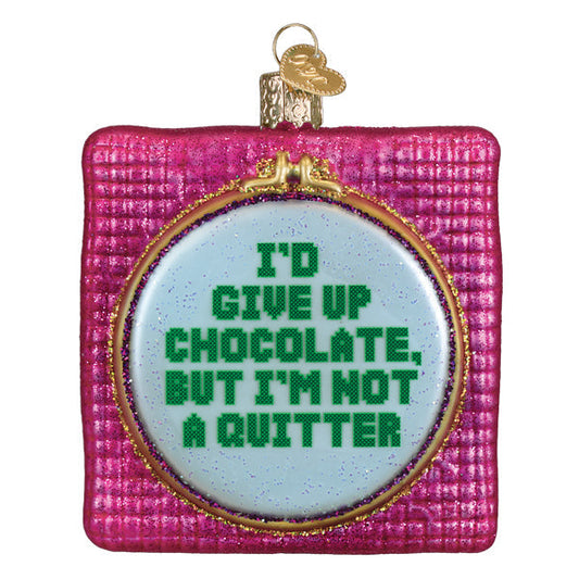 a christmas ornament with a white circle with green text