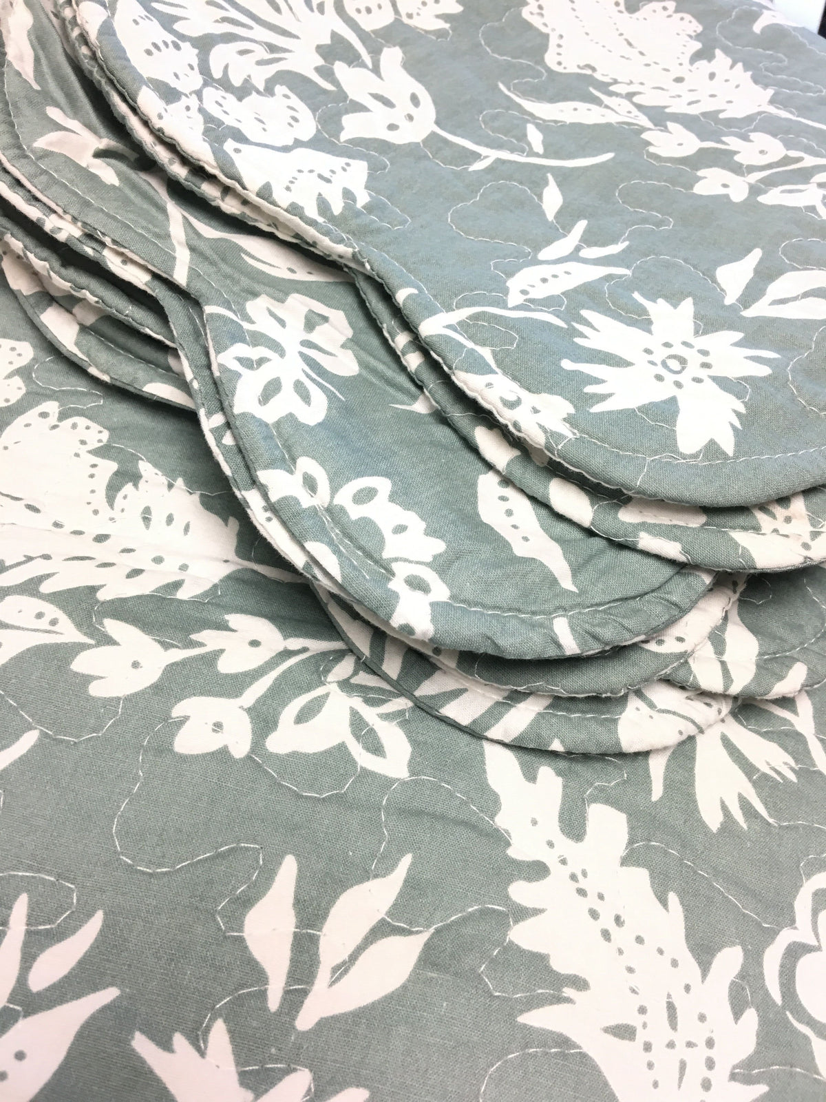 a stack of cloths with white flowers on it