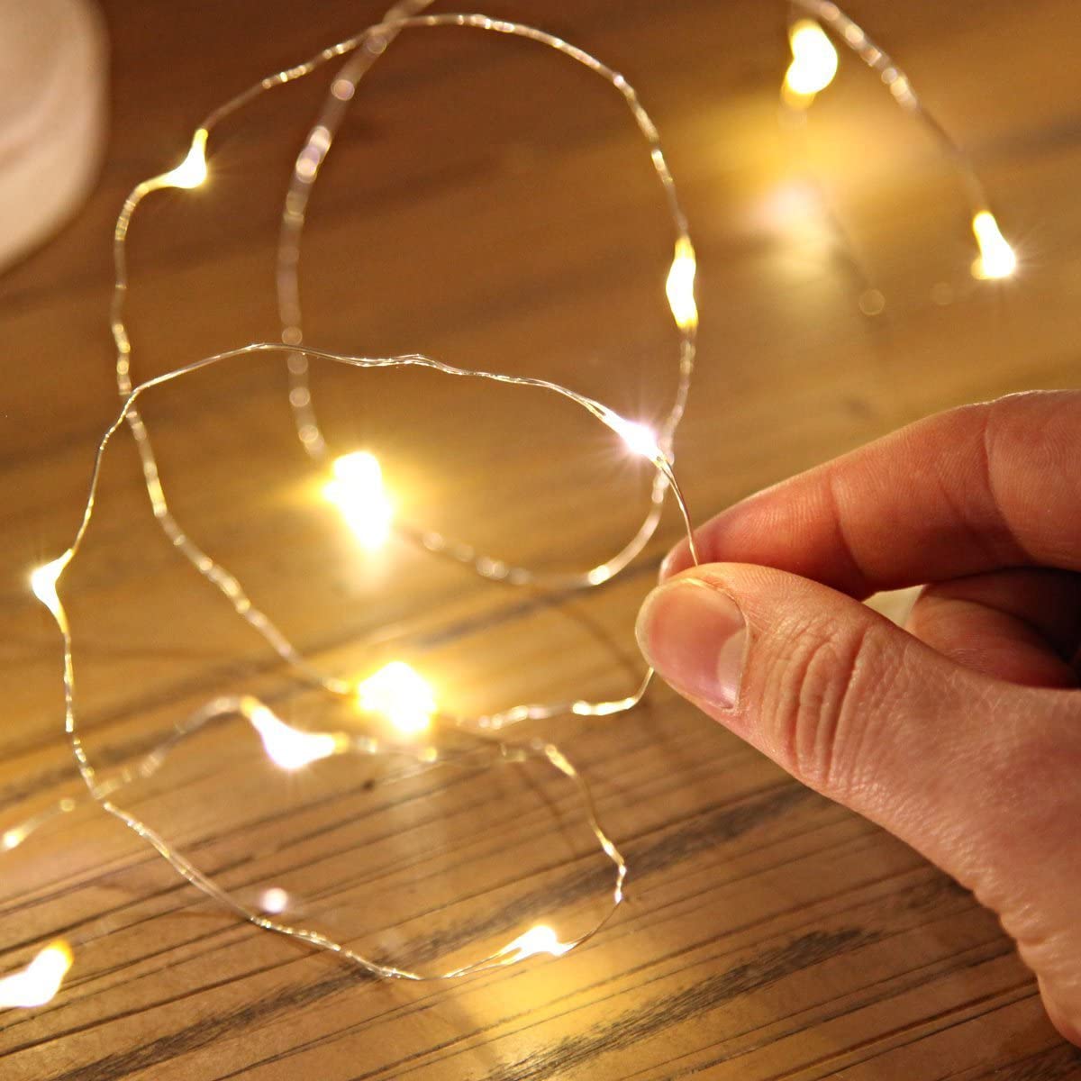 a hand holding a string of lights