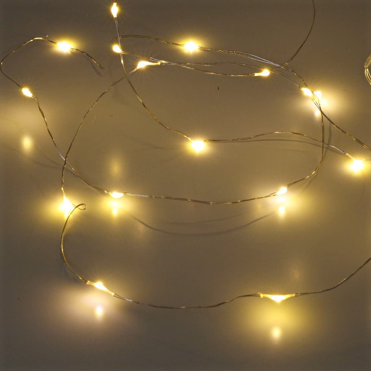 a string of lights on a white surface