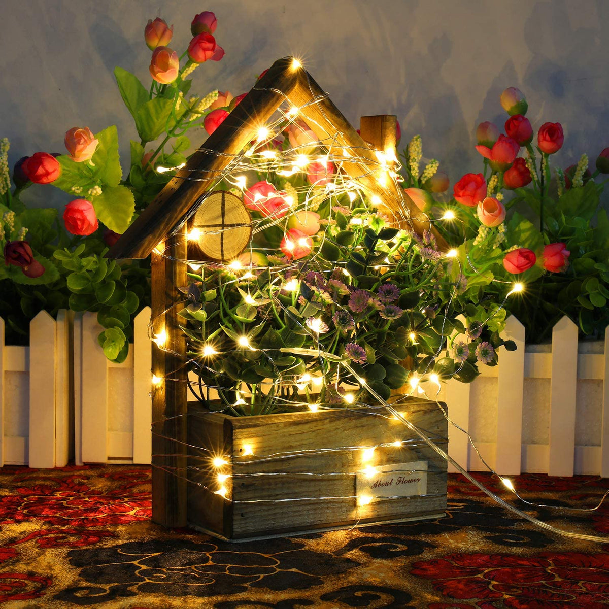 a plant with lights in a wooden box