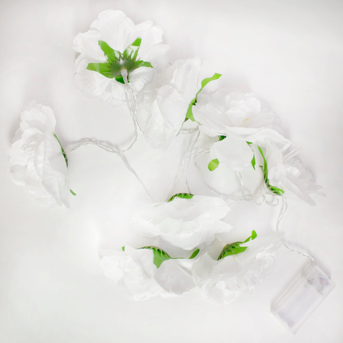 a white flower garland with green leaves