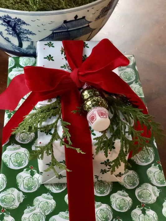 a wrapped present with a red ribbon and a bow