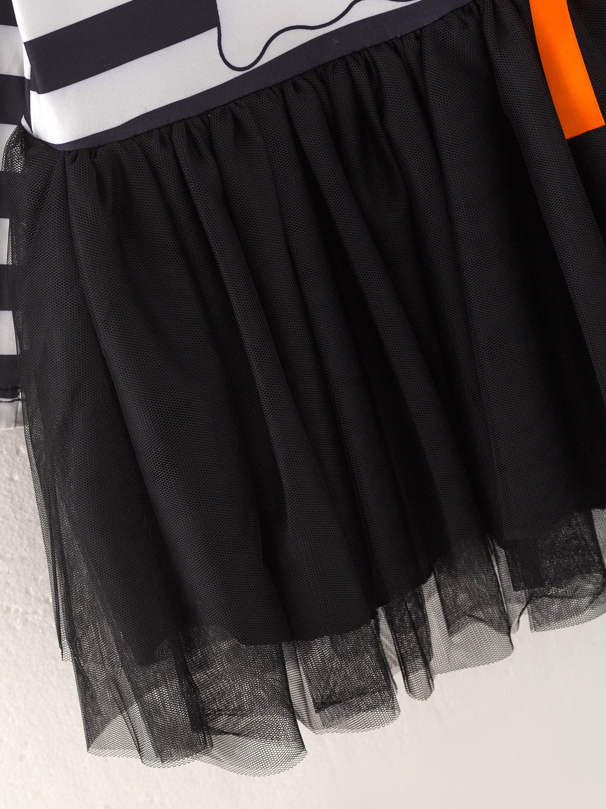 a black and white striped shirt with a black and orange tutu