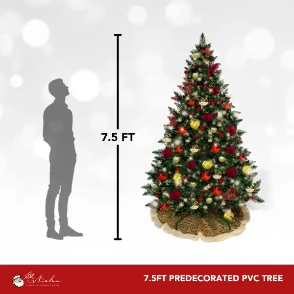 a tall christmas tree with a man standing in front of it