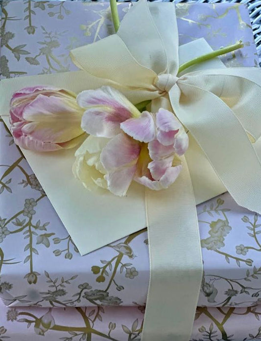 a gift box with a bow and flowers