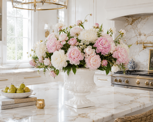 a vase of flowers on a marble counter