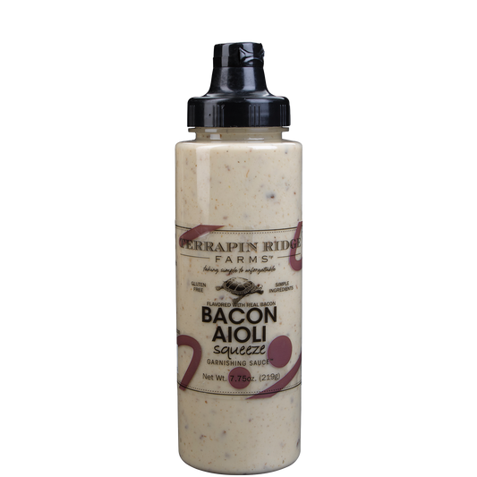 a bottle of sauce with a black lid