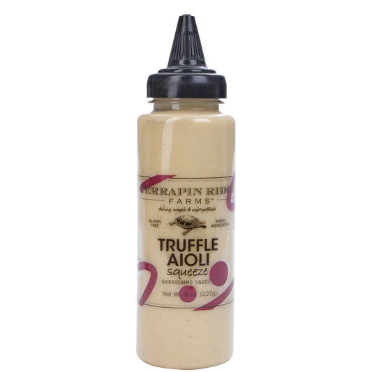 a bottle of sauce with a black lid