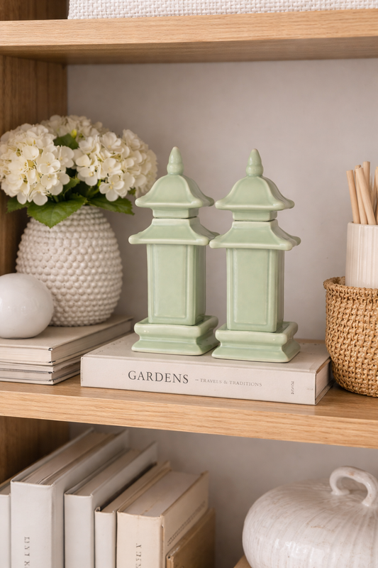 a book and vase of flowers on a shelf