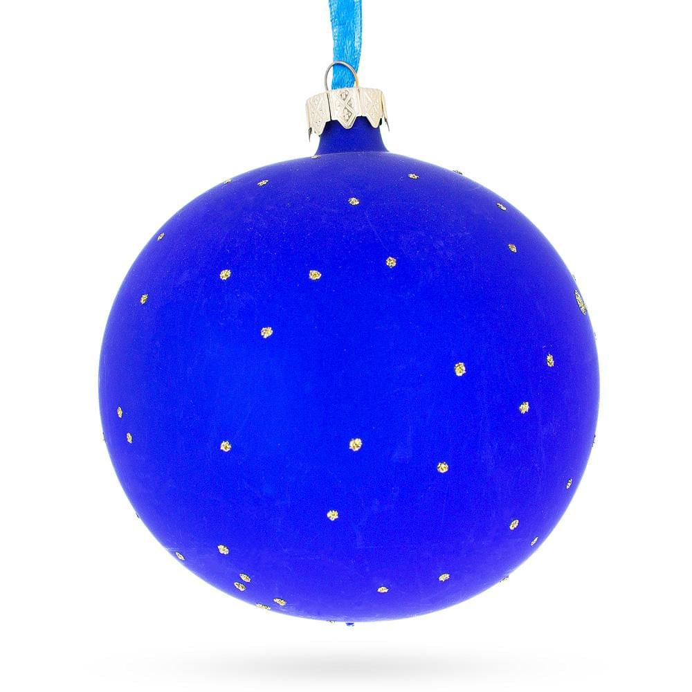 a blue christmas ornament with gold dots