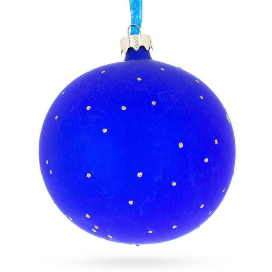 a blue christmas ornament with gold dots