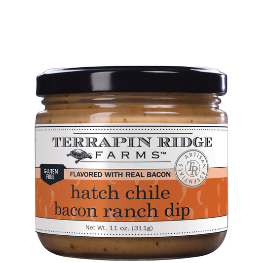 a jar of dip with a black lid