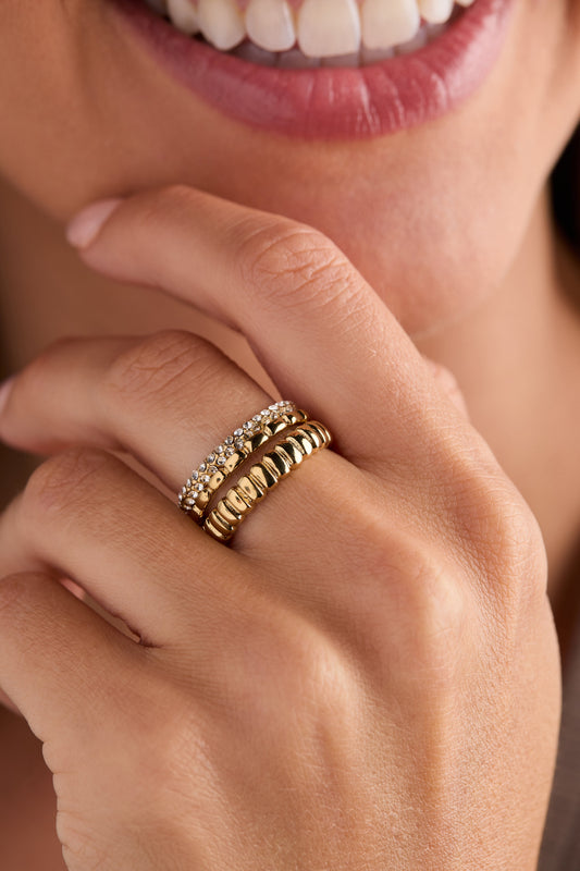 a close up of a woman's hand with a ring on her finger