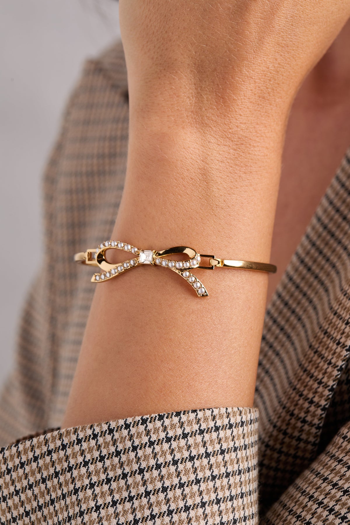 a person wearing a gold bracelet