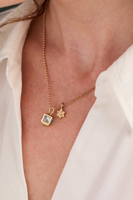 a woman wearing a gold necklace