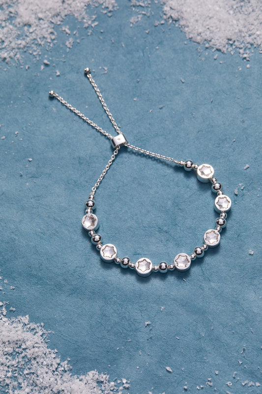 a silver bracelet with white stones