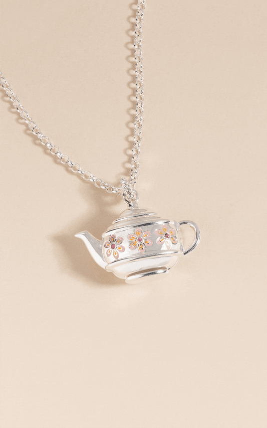 a silver tea pot necklace