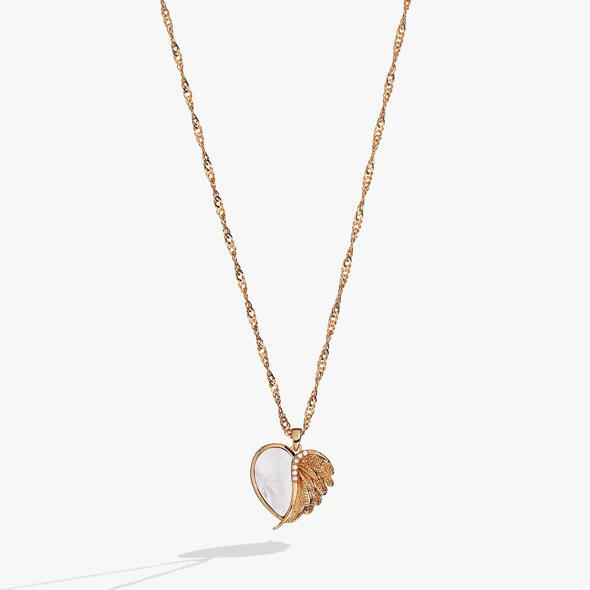 a gold necklace with a heart shaped pendant