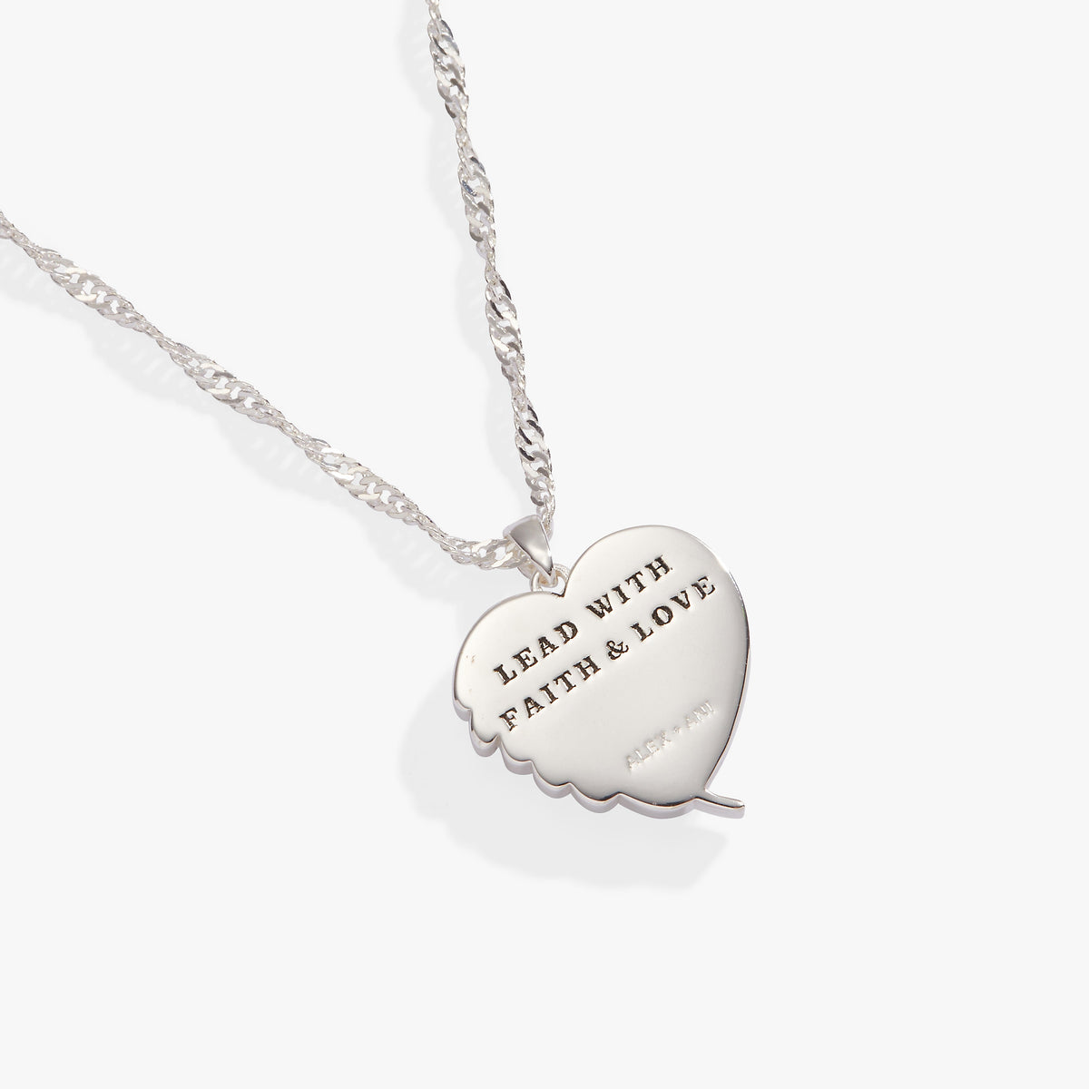 a silver heart necklace with a message on it