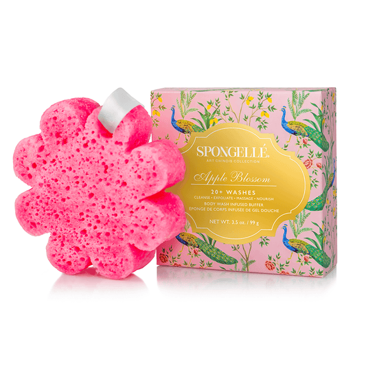 a pink sponge in a flower shape with a box