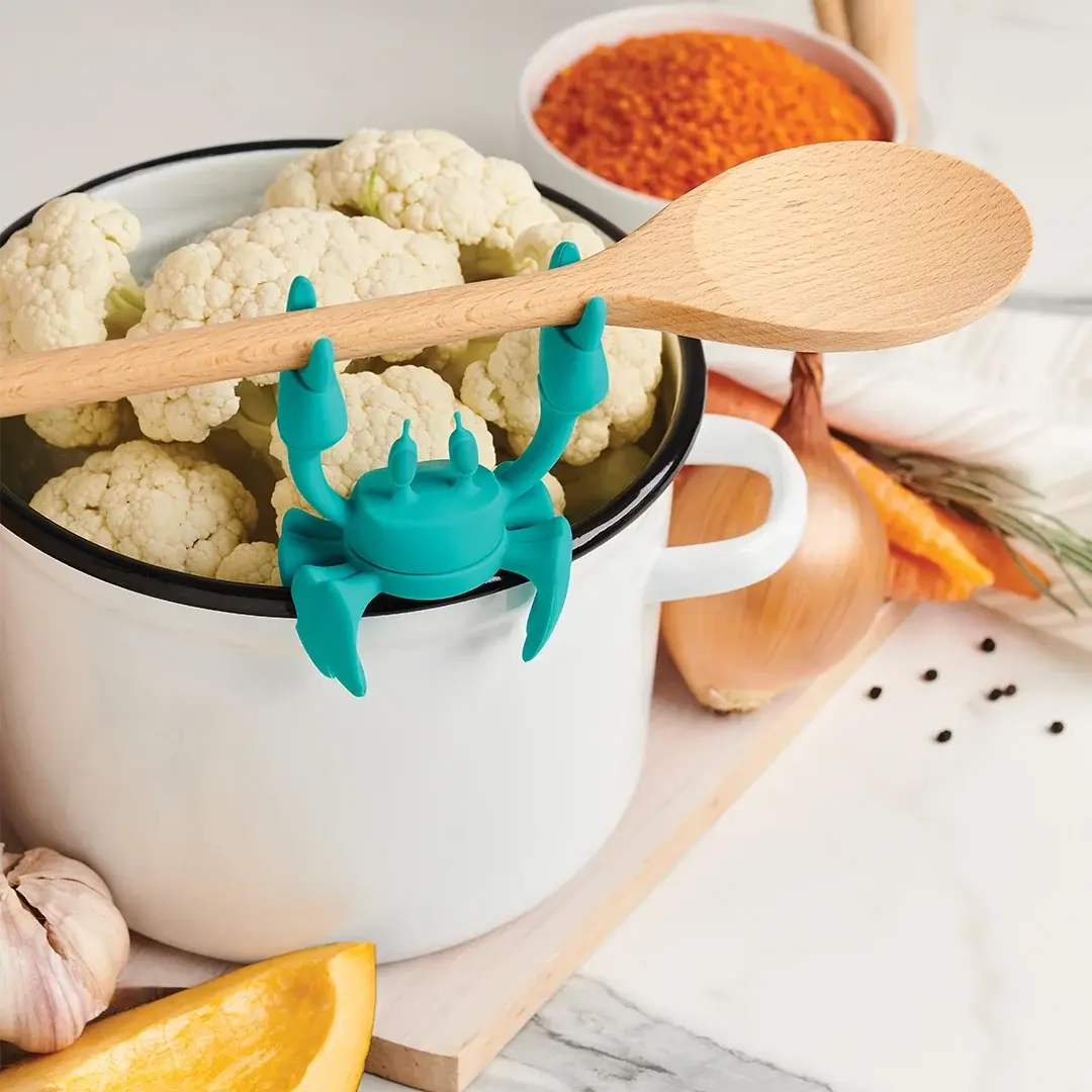 cauliflower in a pot with a wooden spoon in it