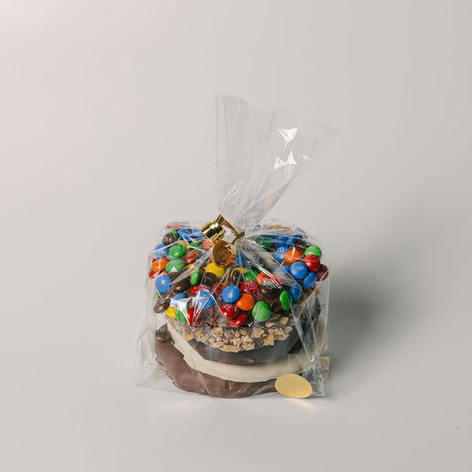 a chocolate cake with candy in a plastic bag
