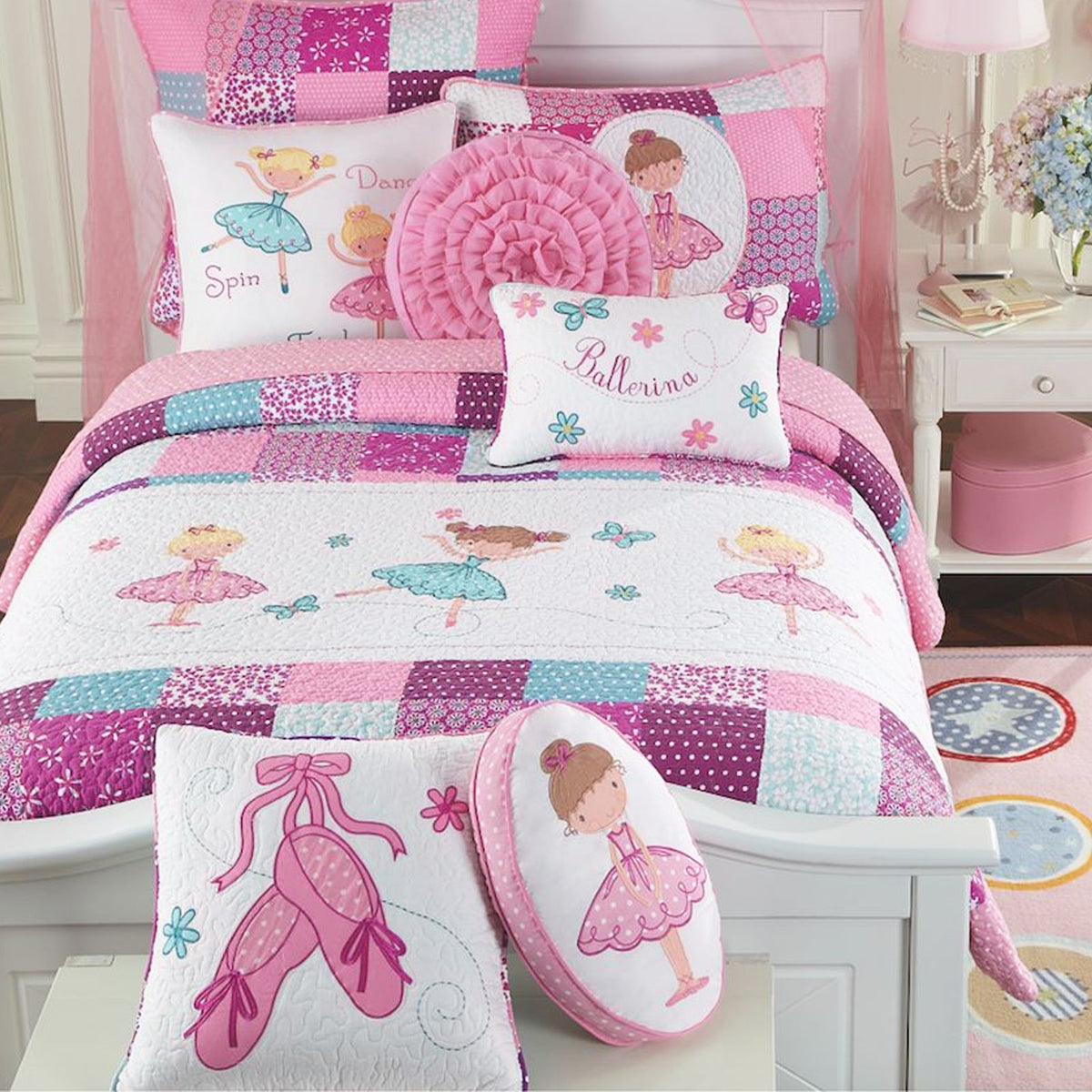 a bed with pink and white bedding