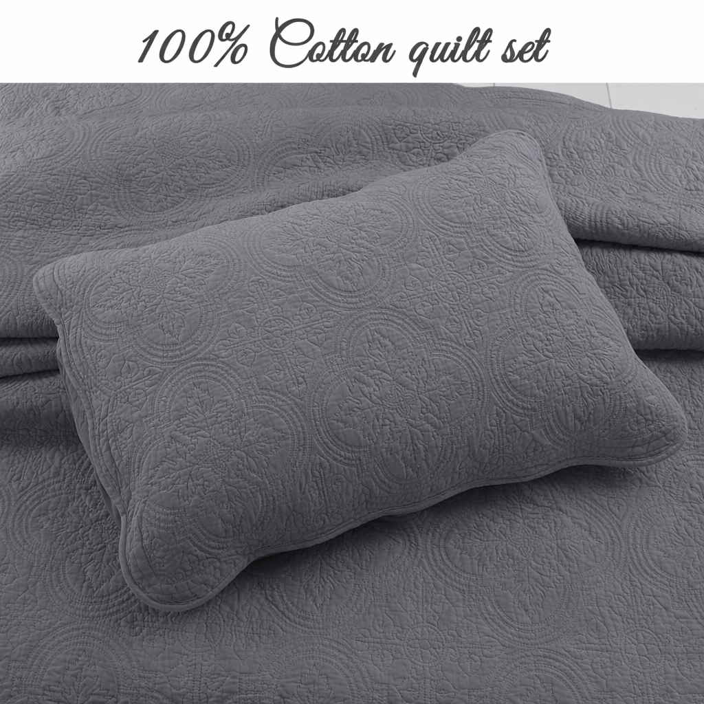 a grey quilt set with a pillow