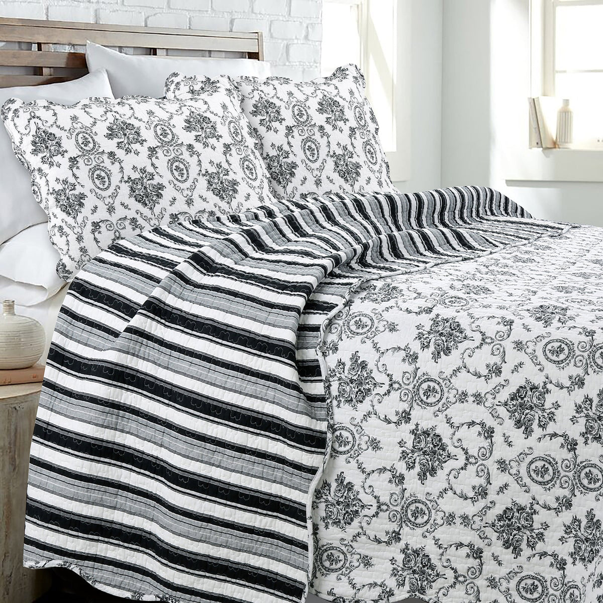 a bed with a striped blanket and pillows