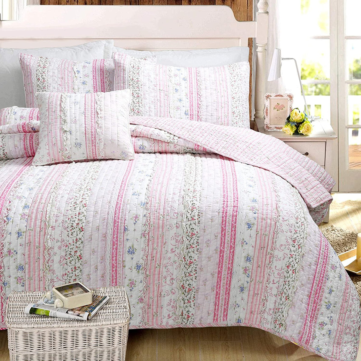 a bed with pink and white bedding