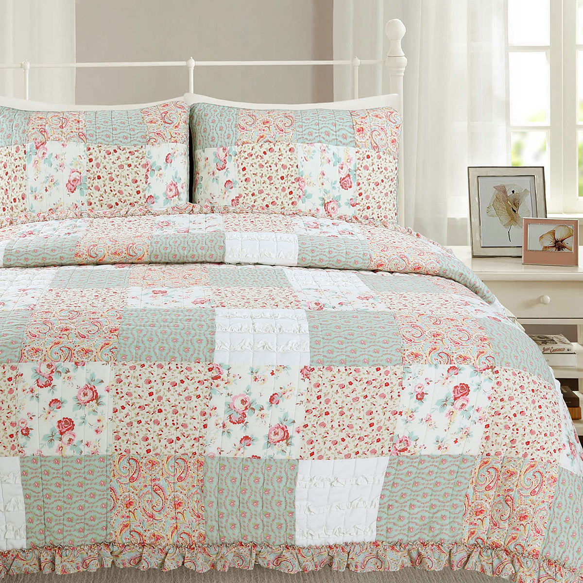 a bed with a quilt and pillows