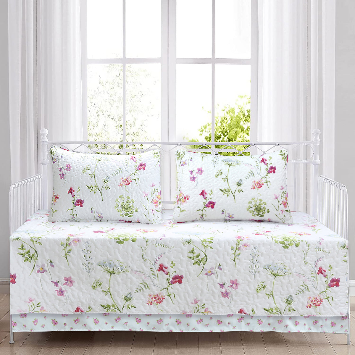 a bed with white sheets and flowers on it