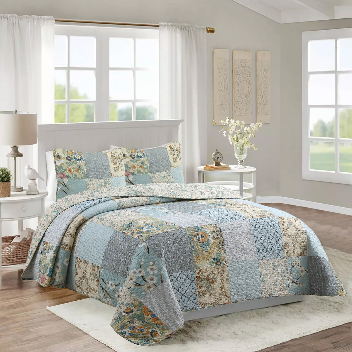 a bed with a quilt in a room with windows