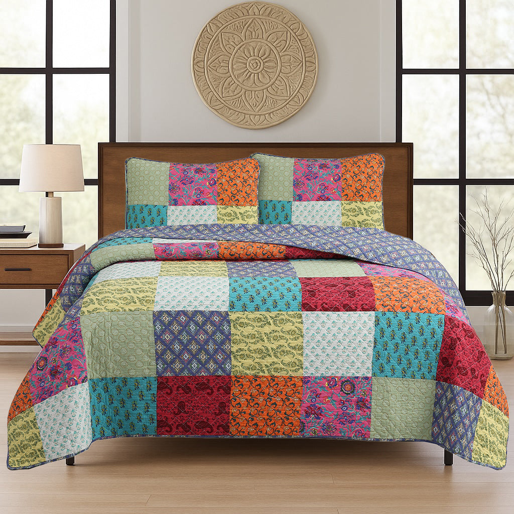 a bed with colorful quilt and pillows