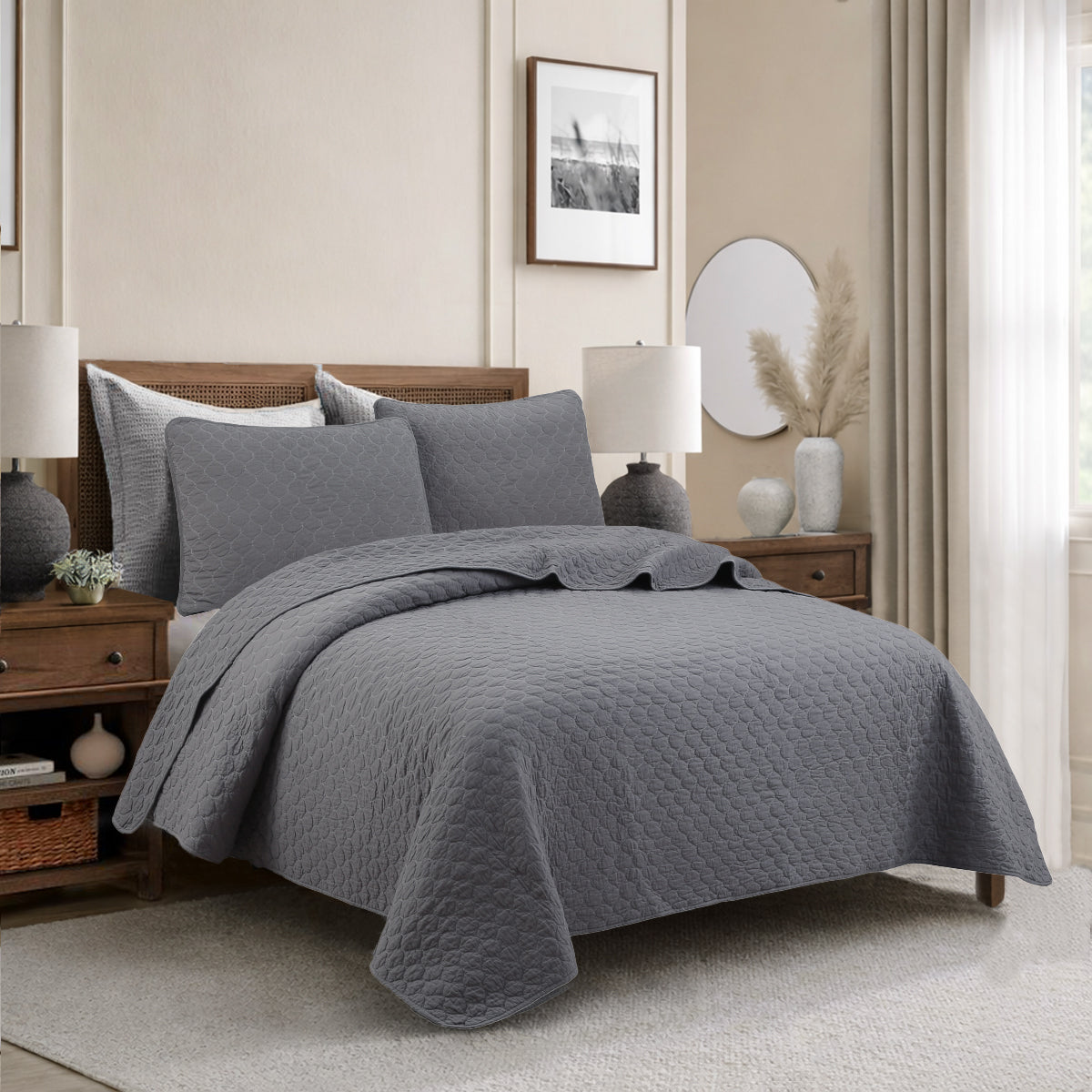 a bed with a grey blanket and lamps