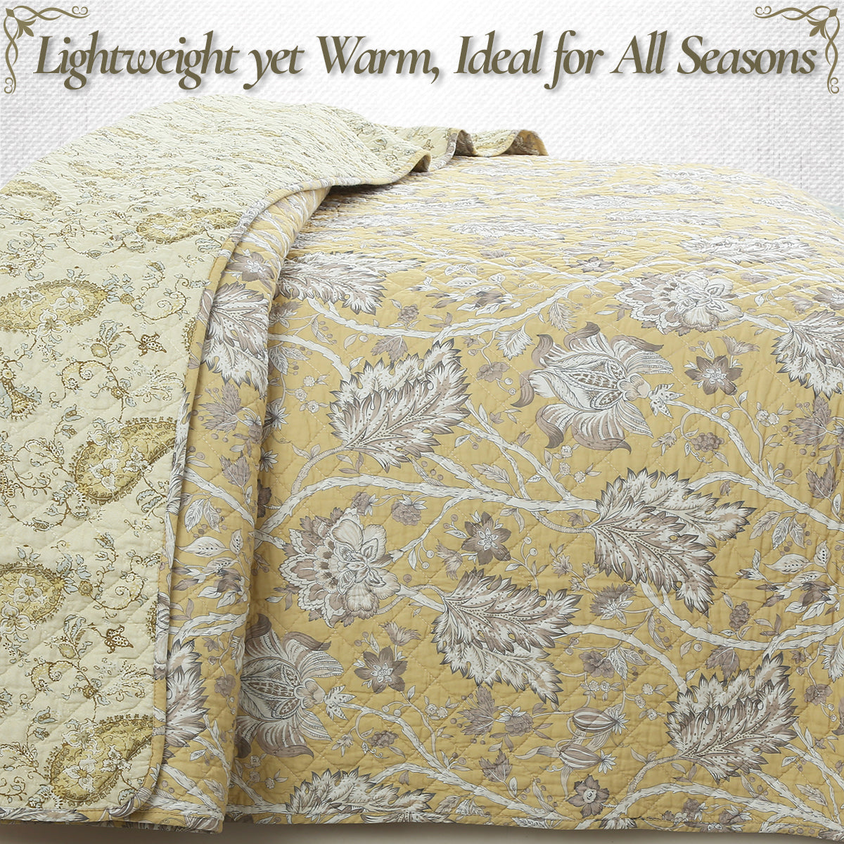 a yellow and white quilt with floral design