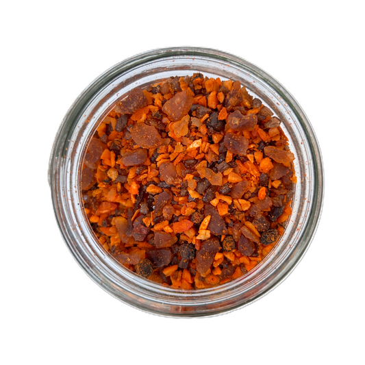 a glass jar with orange and black crystals