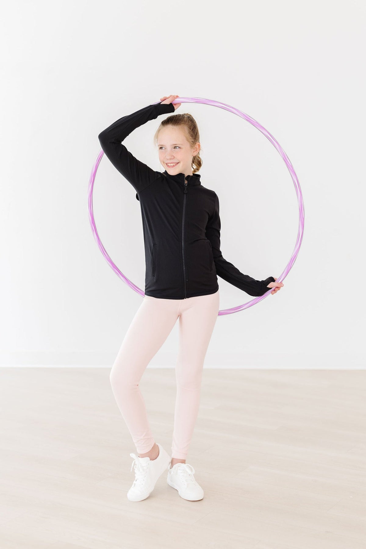 a girl holding a hula hoop