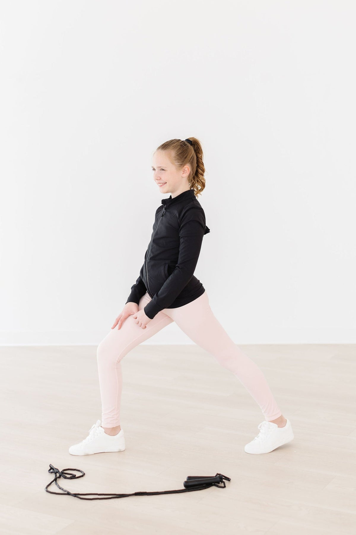 a girl in black shirt and pink pants