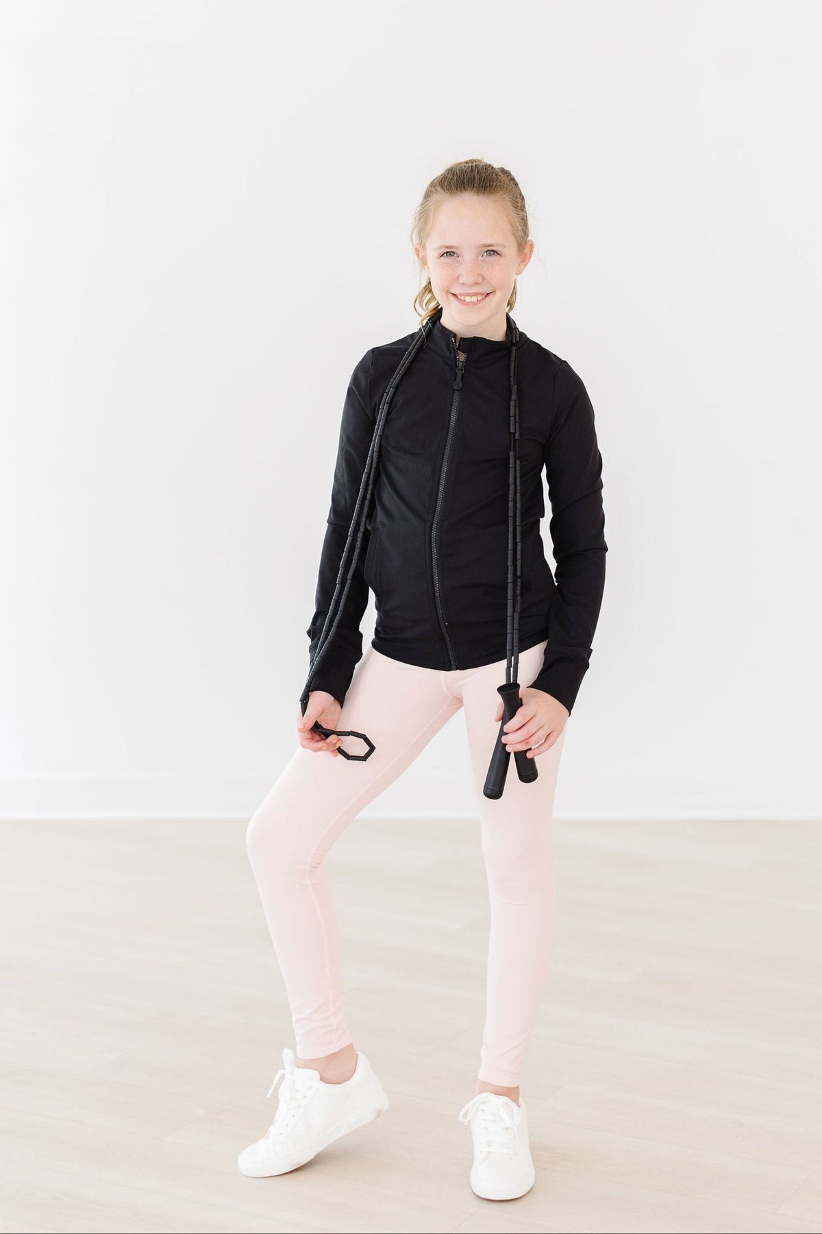 a girl holding a skipping rope