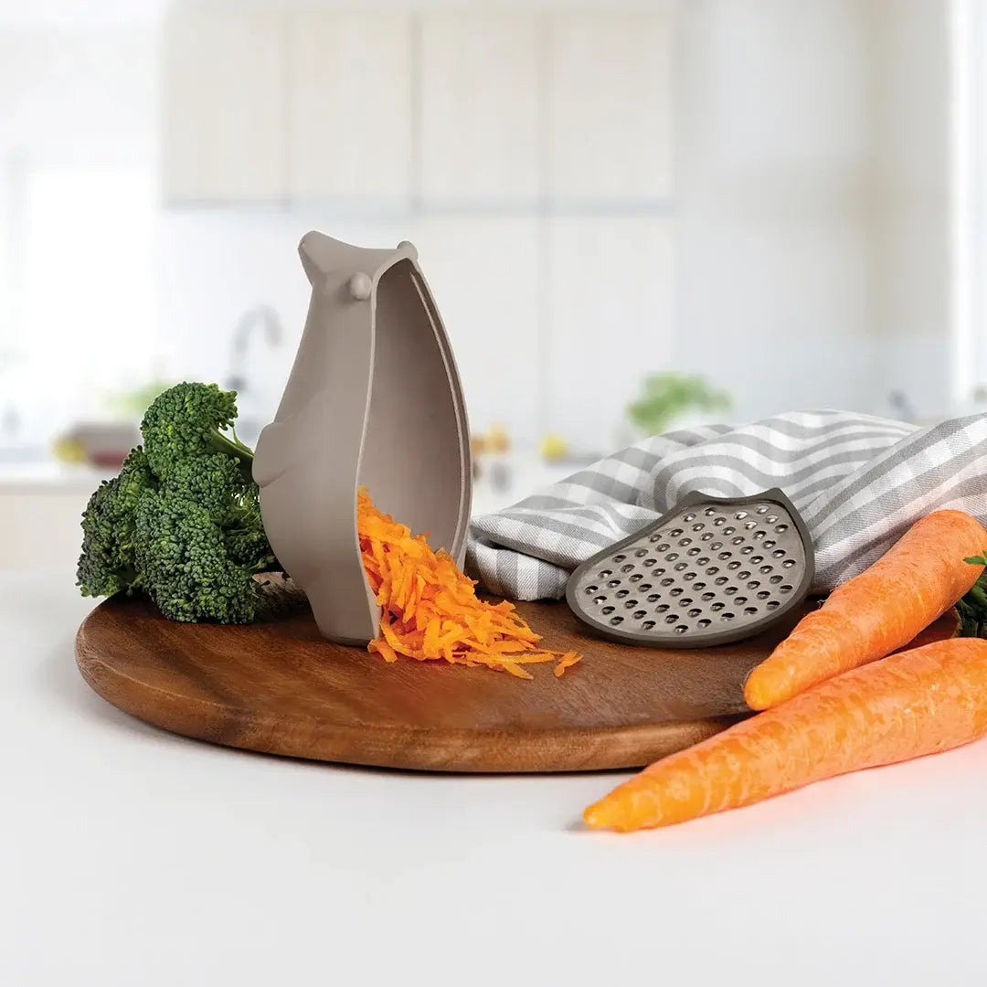 carrots and carrots on a cutting board with a grater and a carrot