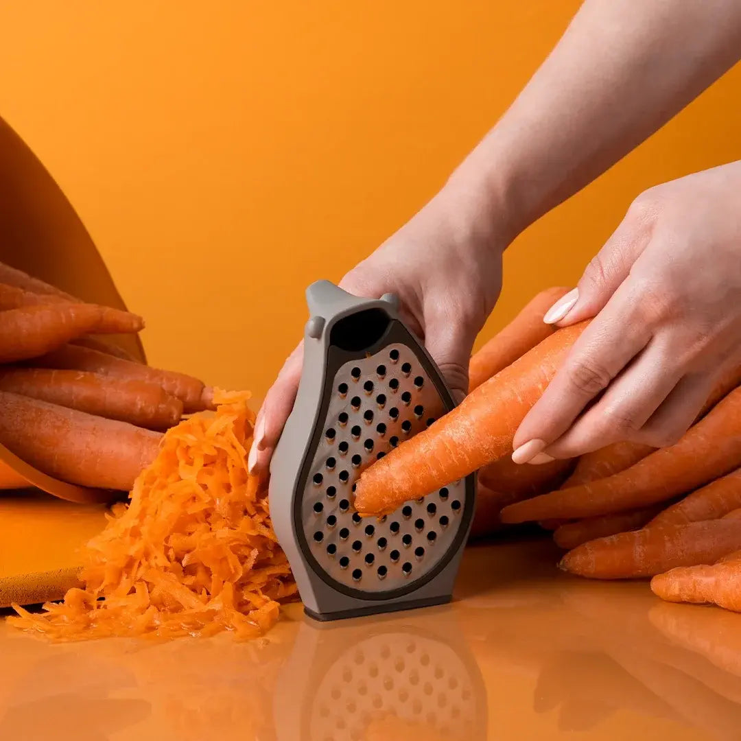 a person grating a carrot